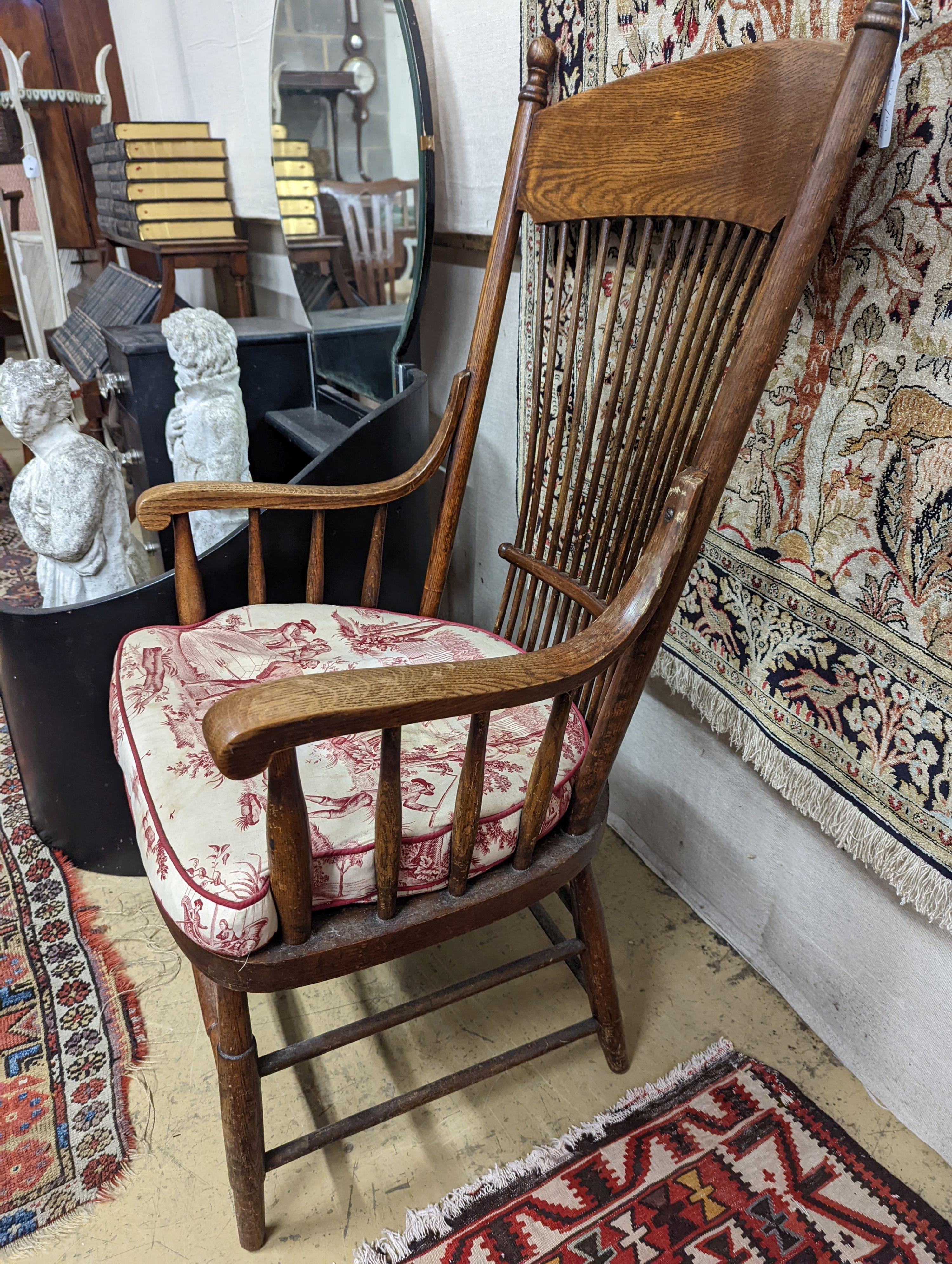 An early 20th century oak and beech American spindle-back elbow chair, width 60cm, depth 45cm, height 112cm